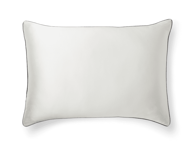 A plain, rectangular "Silk Pillowcase" with slightly curved corners is shown against a green background. The pillowcase appears smooth and has a soft sheen. There is a faint shadow beneath and to the right of the pillowcase, giving it a three-dimensional appearance.