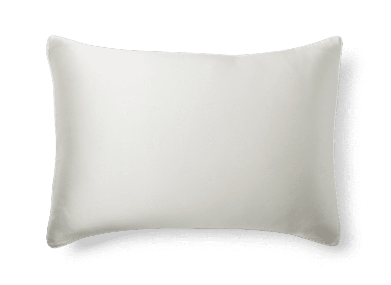 The Silk Pillowcase, featuring a plain white rectangular design with a smooth, clean surface, is displayed against a transparent background. Subtle shadows around the edges add a slight depth to the image.