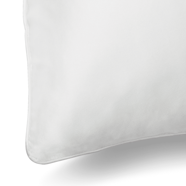 Close-up of a Silk Pillowcase with smooth fabric. The corner of the pillowcase is visible, showcasing clean lines and a minimalist design. The background is plain and non-distracting, emphasizing the pillowcase's simplicity and softness.
