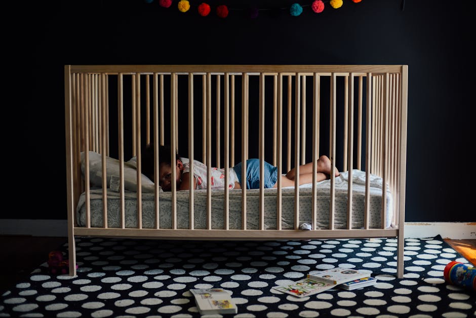 a child lying in a crib