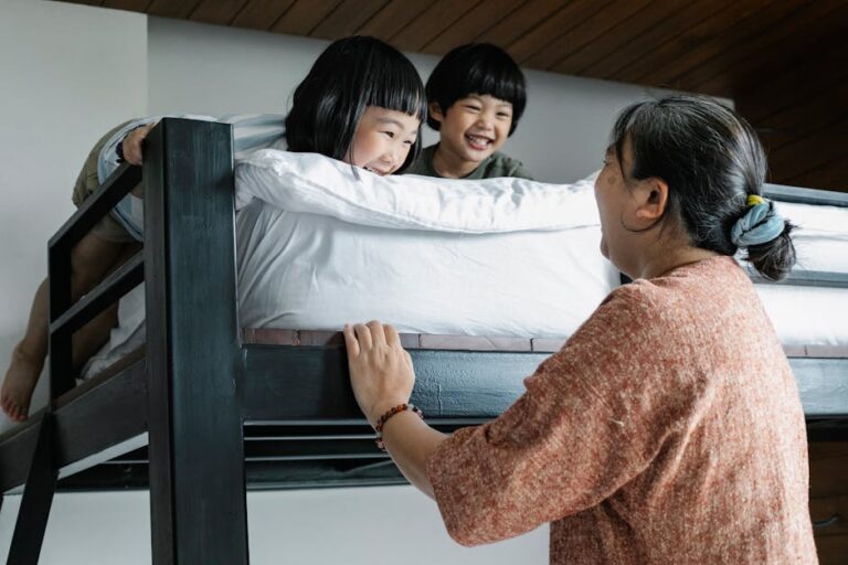 a woman holding a bed with two children