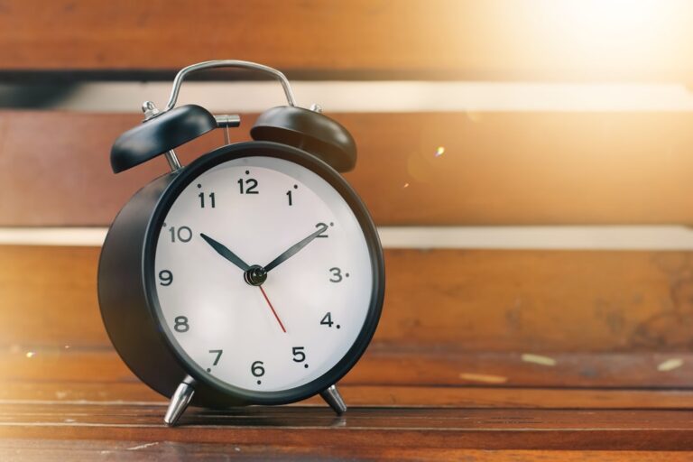 a black alarm clock on a wooden surface