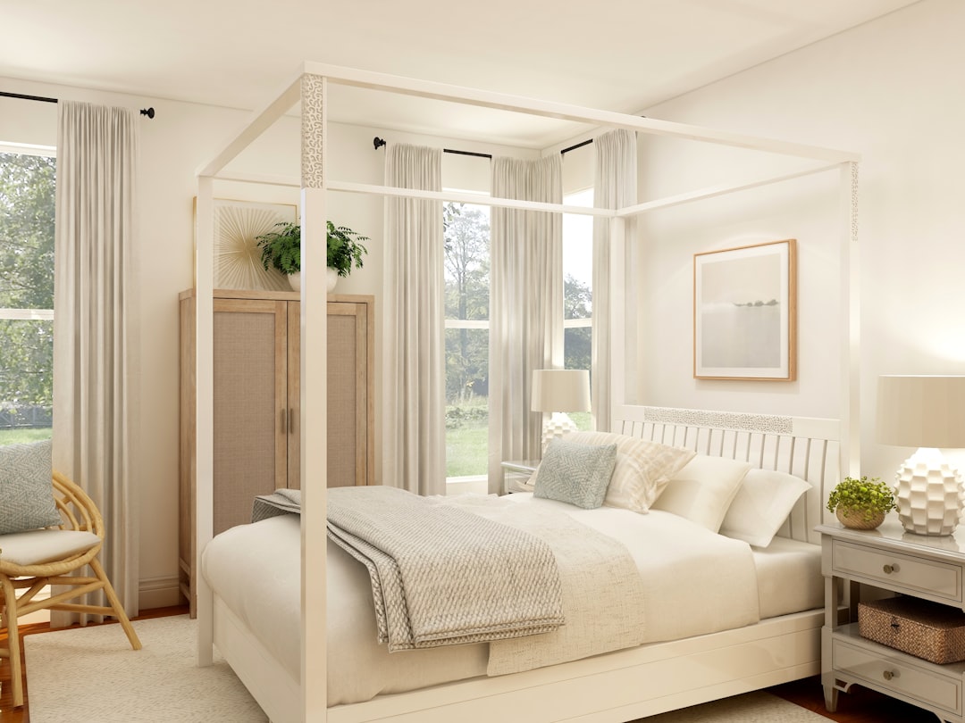 a white bed with a white canopy bed