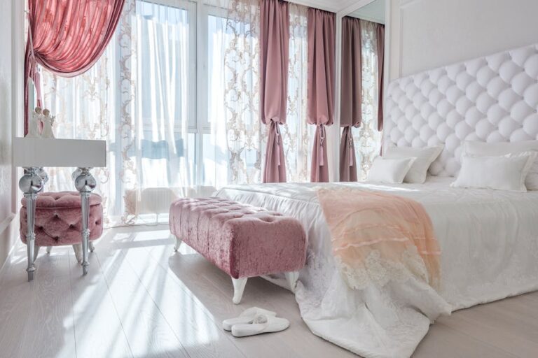 a bedroom with pink curtains and a bed