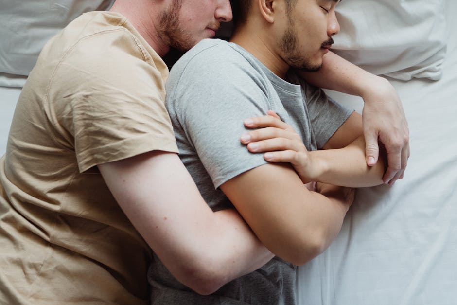 a man and woman sleeping on a bed