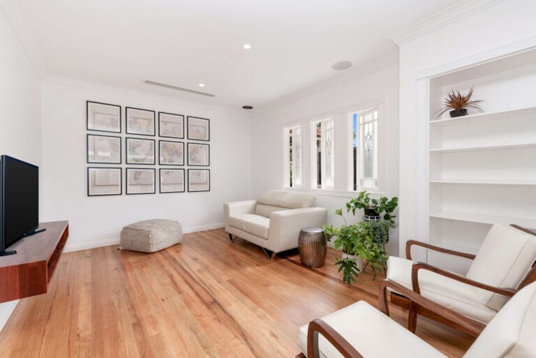 a room with white furniture and wood floor