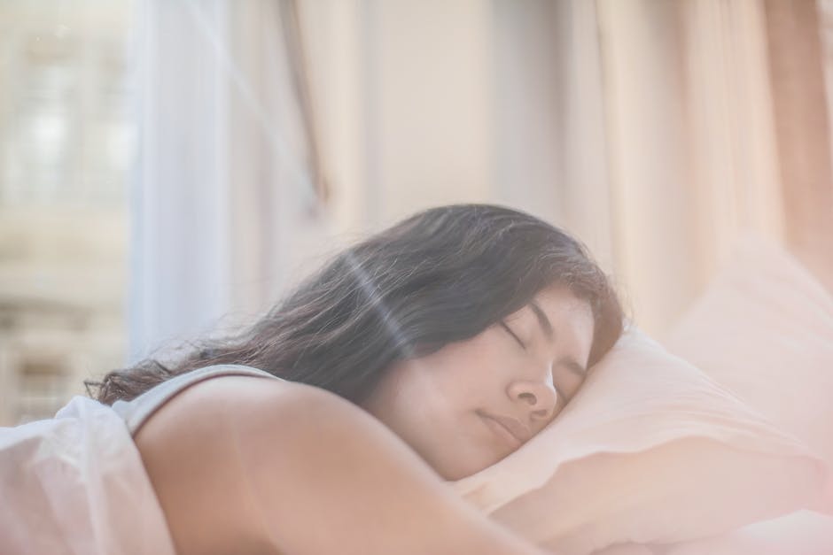 a woman sleeping on a bed