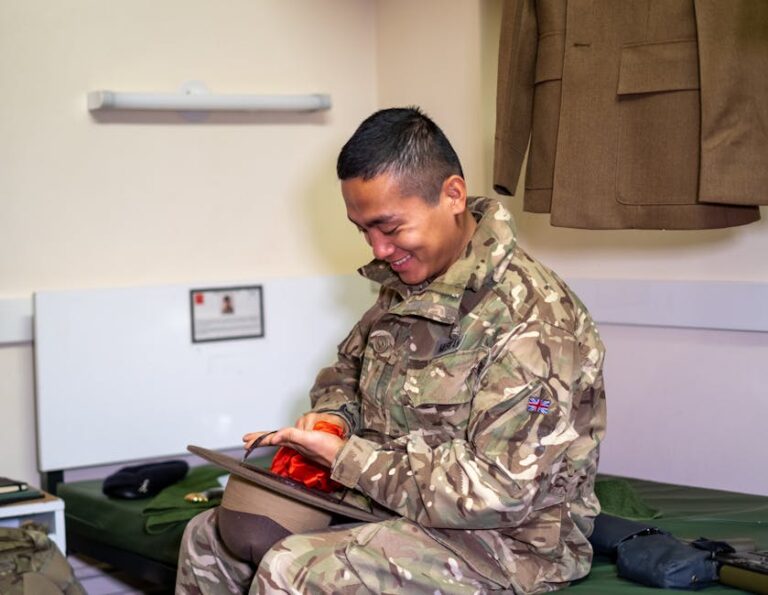 a man in military uniform sitting on a bed