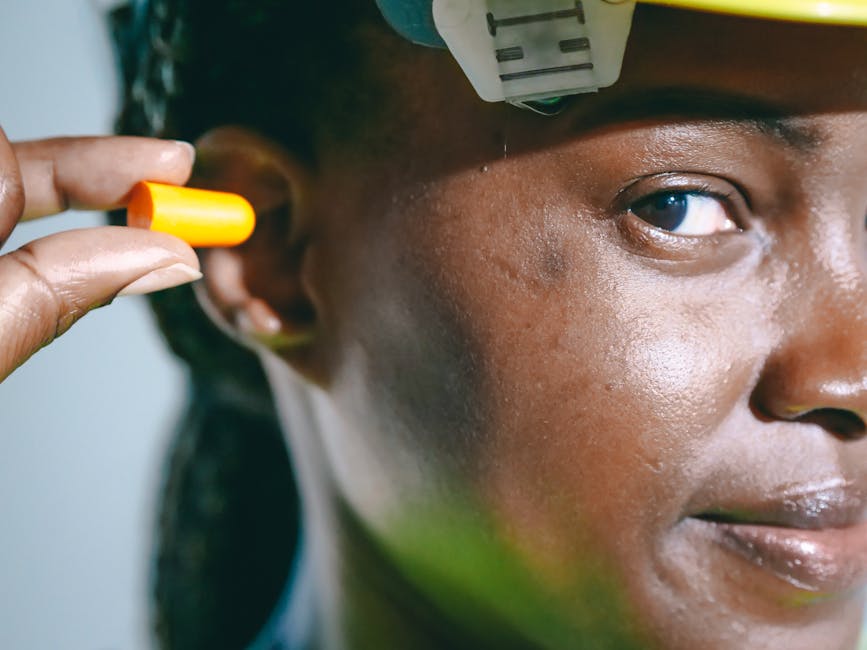 a woman wearing a hard hat and earplugs