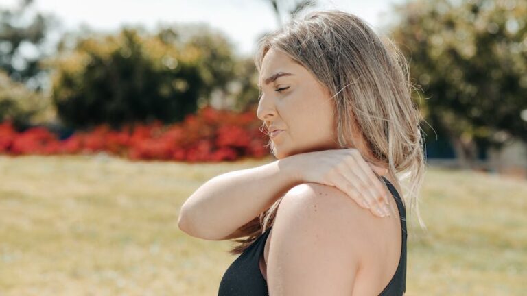 a woman holding her shoulder