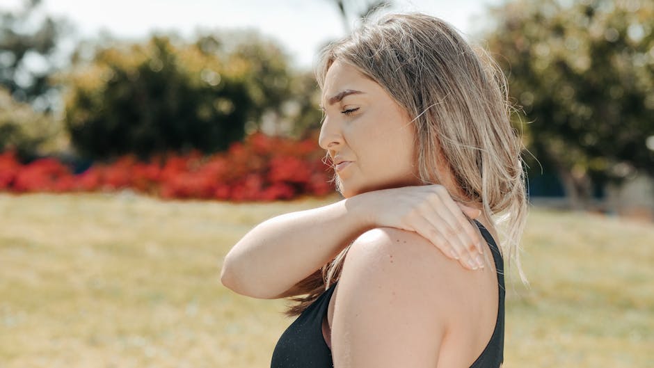 a woman holding her shoulder