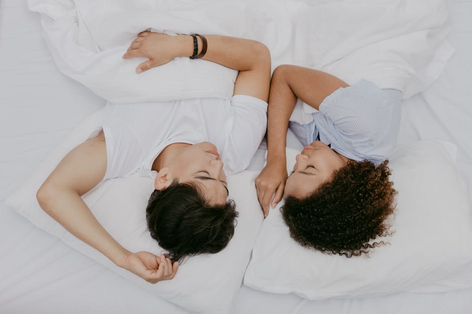 a man and woman lying in bed