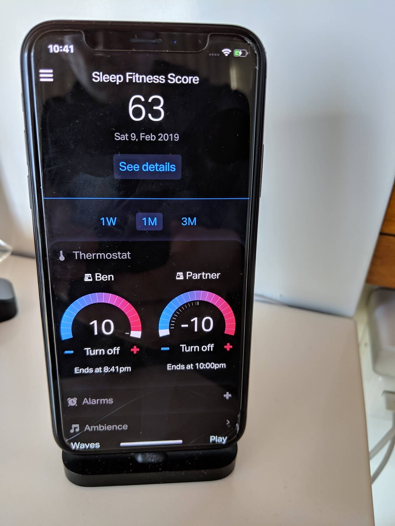 a smart phone with a screen showing the temperature and time