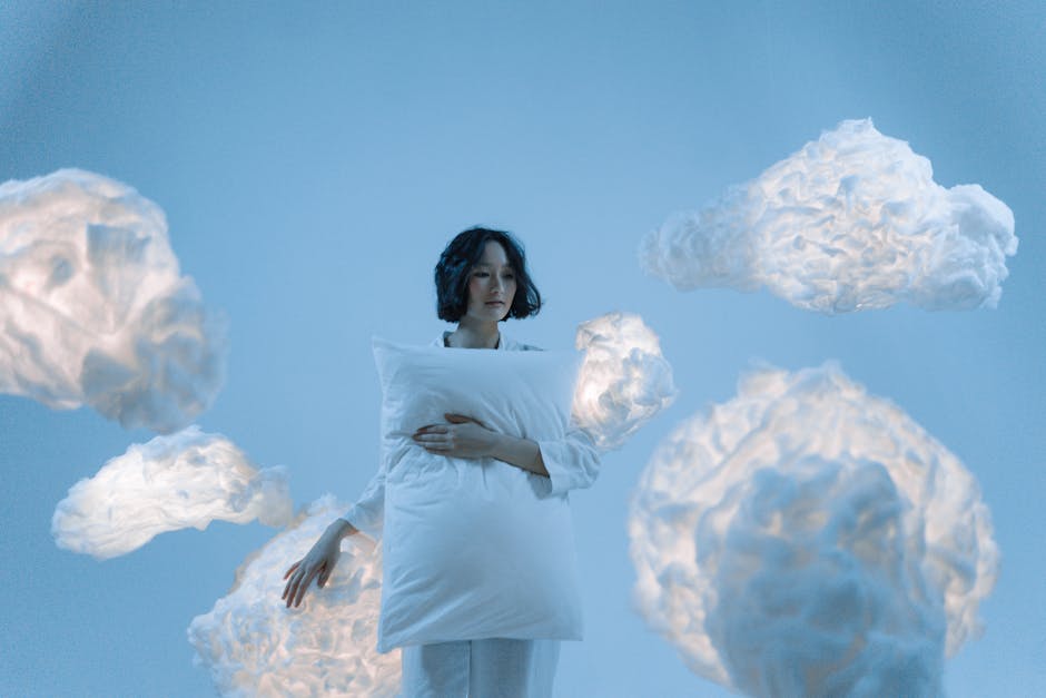 a woman holding a pillow surrounded by clouds