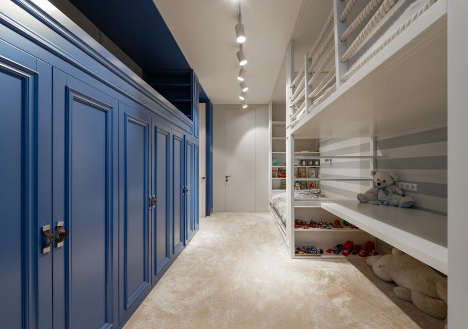 a room with bunk beds and blue cabinets