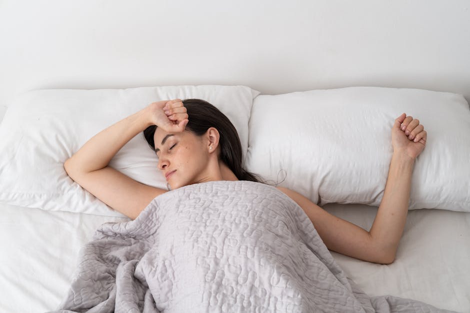 a woman lying in bed with her eyes closed