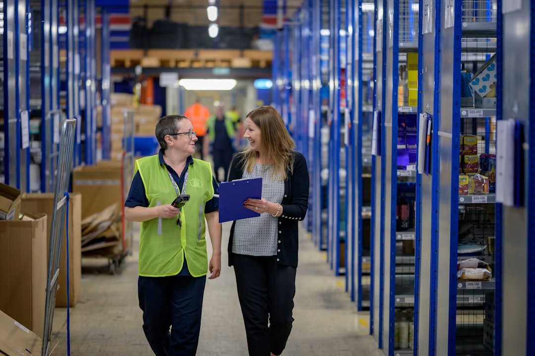 a woman talking to a woman in a warehouse