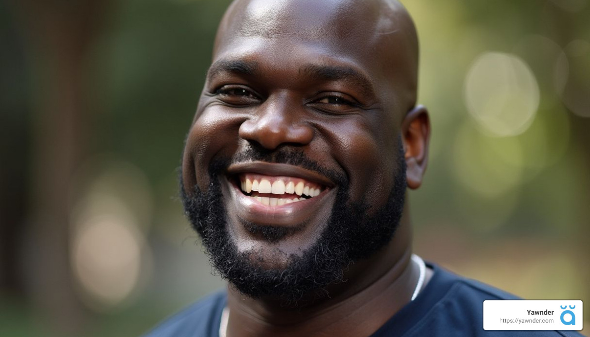 A man with a beard is smiling broadly against a blurred, natural outdoor background. He is wearing a dark shirt. In the bottom right corner, there is a logo featuring the word "Yawner" and a small icon.