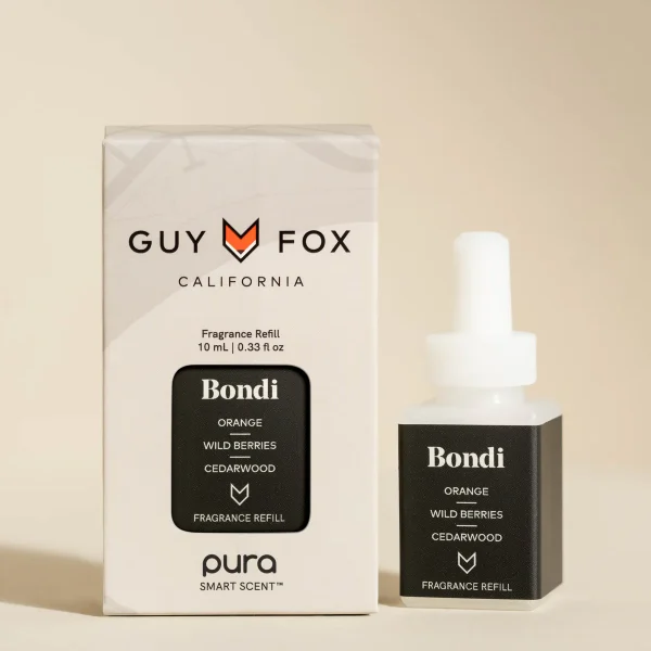 A bottle and box of Guy Fox fragrance refill named "Bondi" featuring notes of orange, wild berries, and cedarwood. The box is positioned on the left, while the bottle with a dropper cap sits on the right against a beige backdrop.