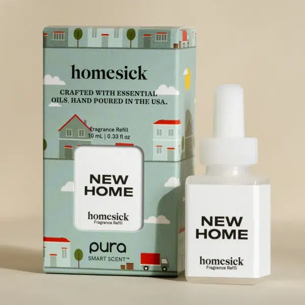 A Homesick fragrance refill labeled "New Home" is placed beside its decorative packaging. The packaging features illustrations of houses and trees, emphasizing a cozy, homey theme. The bottle holds 10 ml (0.33 fl oz) and is for a smart scent diffuser.