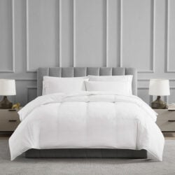 Cozy bed with white comforter.