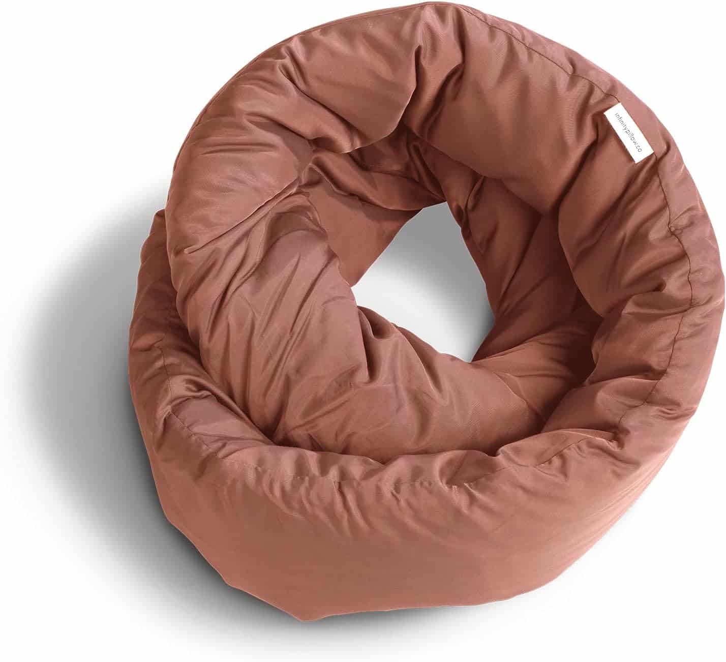 Huzi Infinity travel pillow wrapped around neck on an airplane