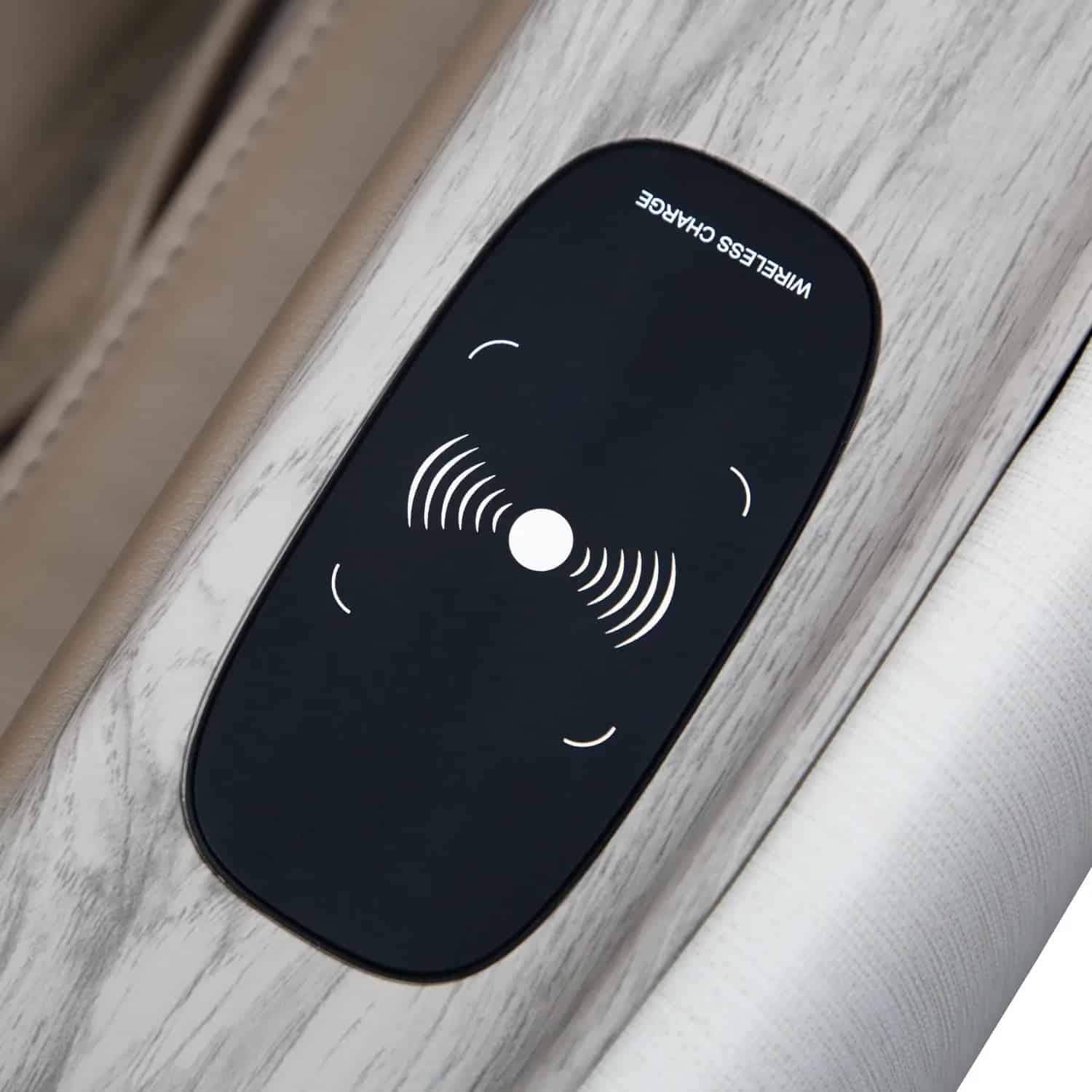 Black wireless charge panel with white icons on a light wood-grain surface