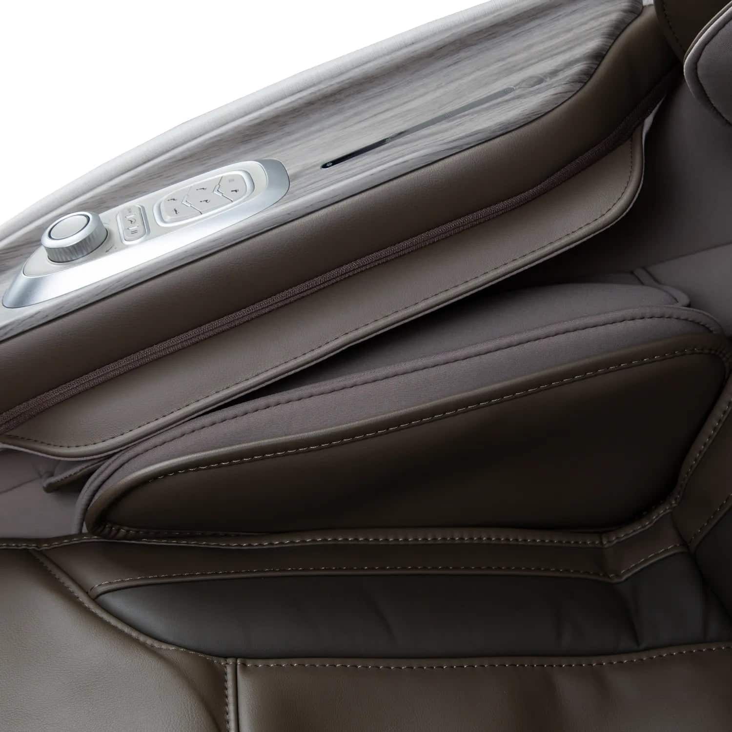 Close-up of a brown leather and wood-grain massage chair with modern controls