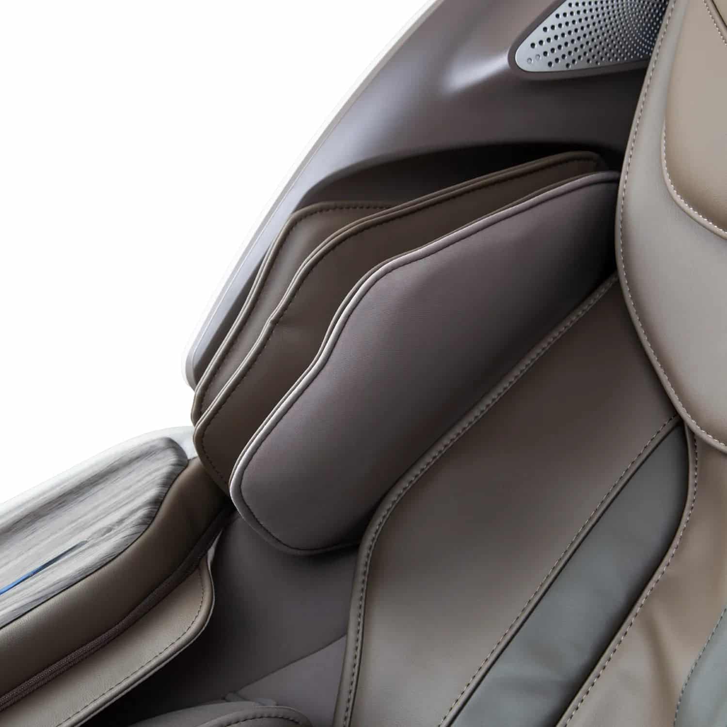 Close-up of a taupe and dark gray leather armrest on a modern massage chair