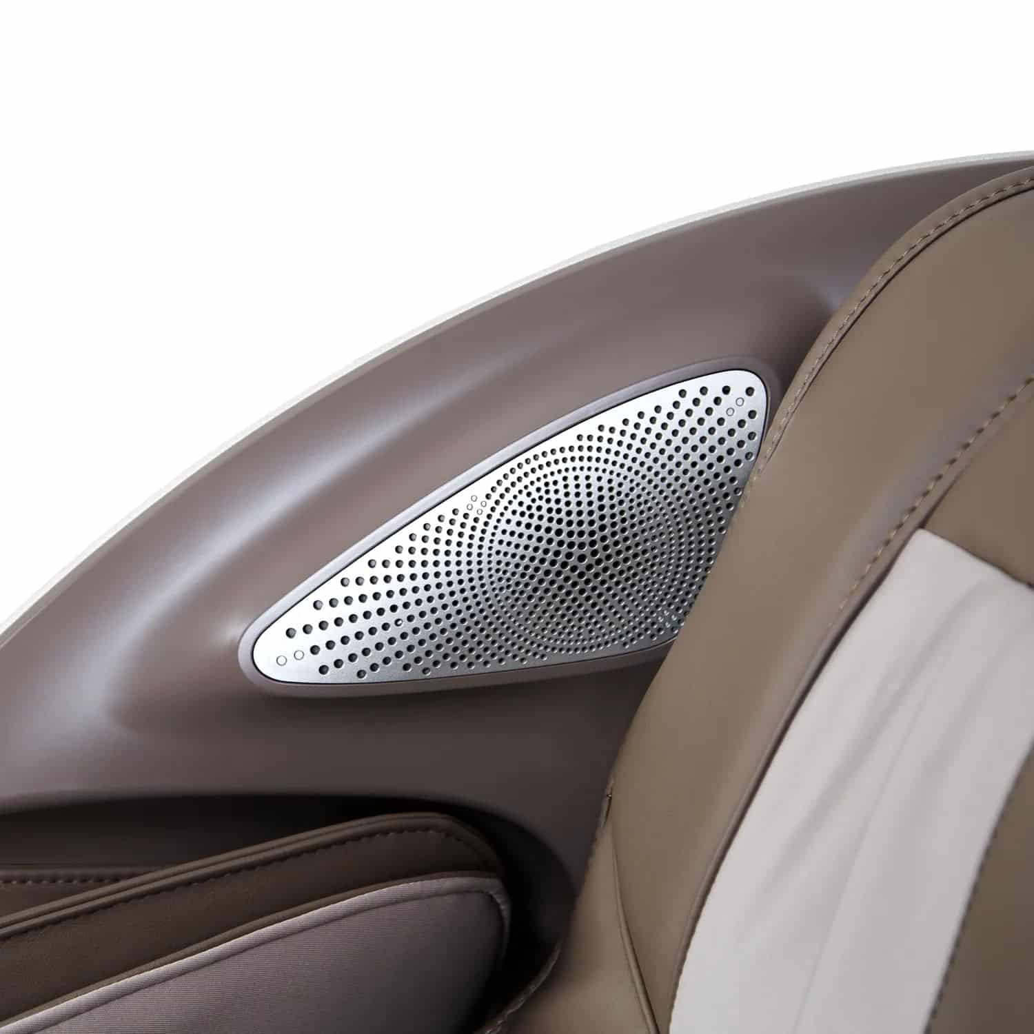 Close-up of a silver speaker grille on a taupe and beige massage chair arm