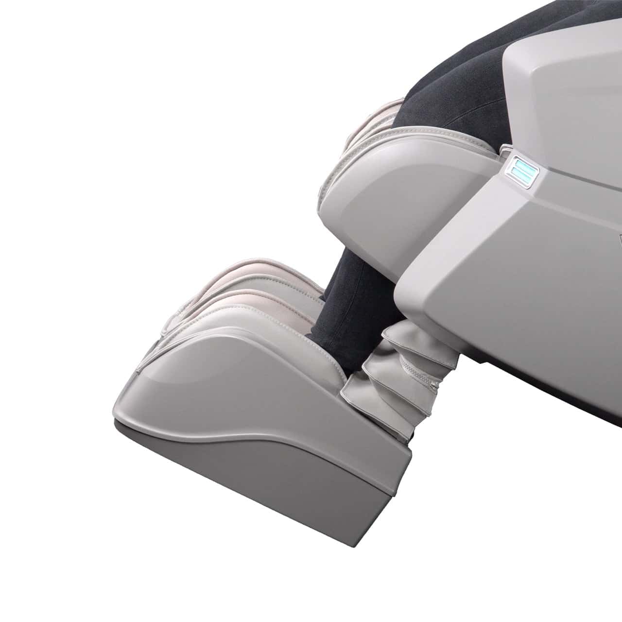 Legs and feet in grey massage chair, with dark pants