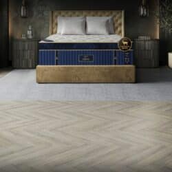 Puffy Legacy mattress within an elegant bedroom with dark wall and herringbone floor