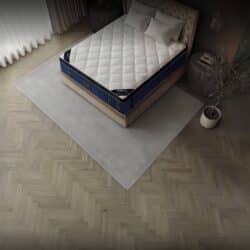 Puffy Legacy mattress and pillows on a bed frame in a chic bedroom setting