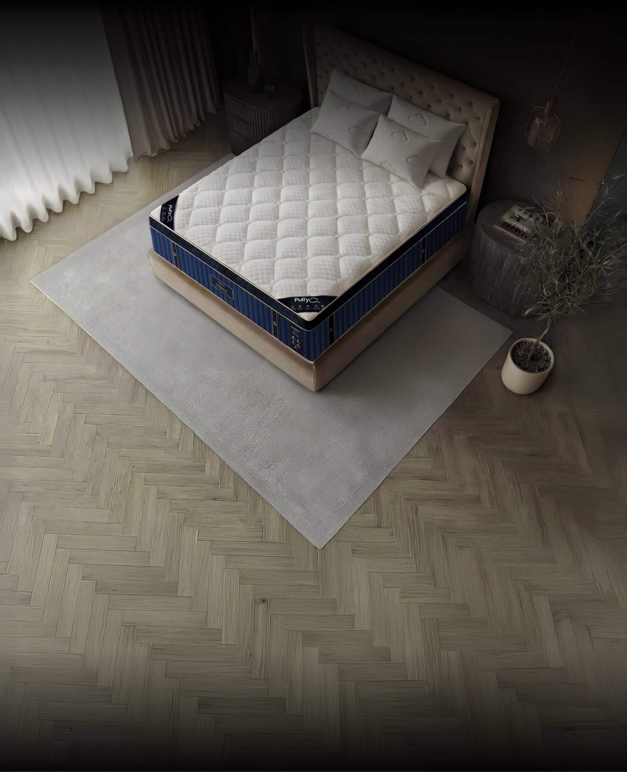 Puffy Legacy mattress and pillows on a bed frame in a chic bedroom setting