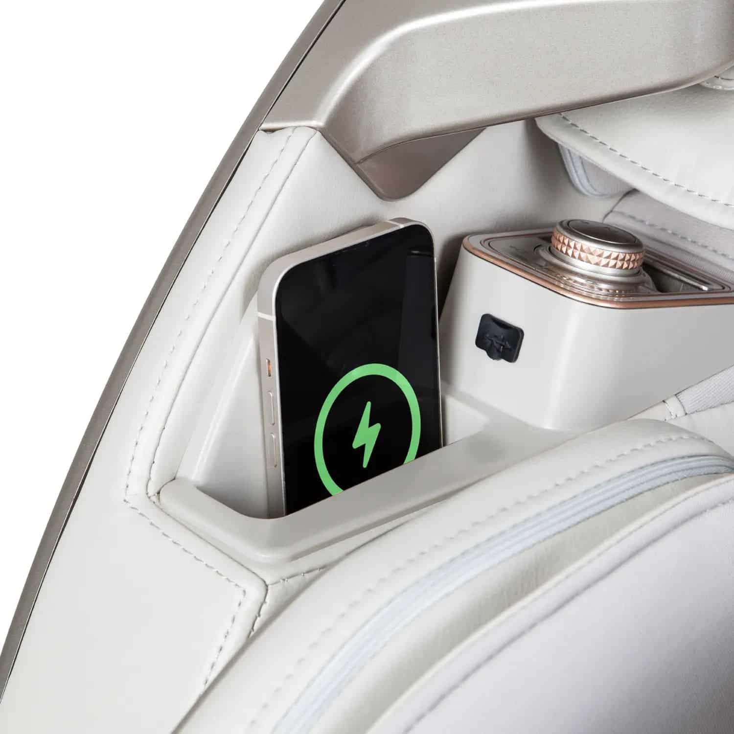 White leather chair with a charging cellphone in a storage compartment