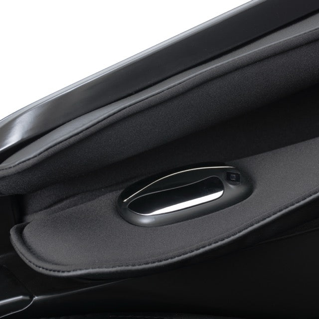 Close-up of a silver, oval hand sensor on the black fabric of a Solo Flex adjustable bed.