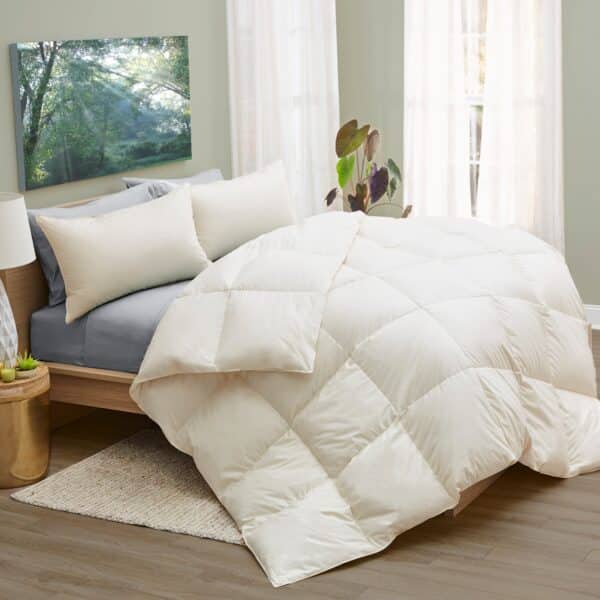LanaDown Organic Comforter draped over a bed with light gray sheets and two pillows