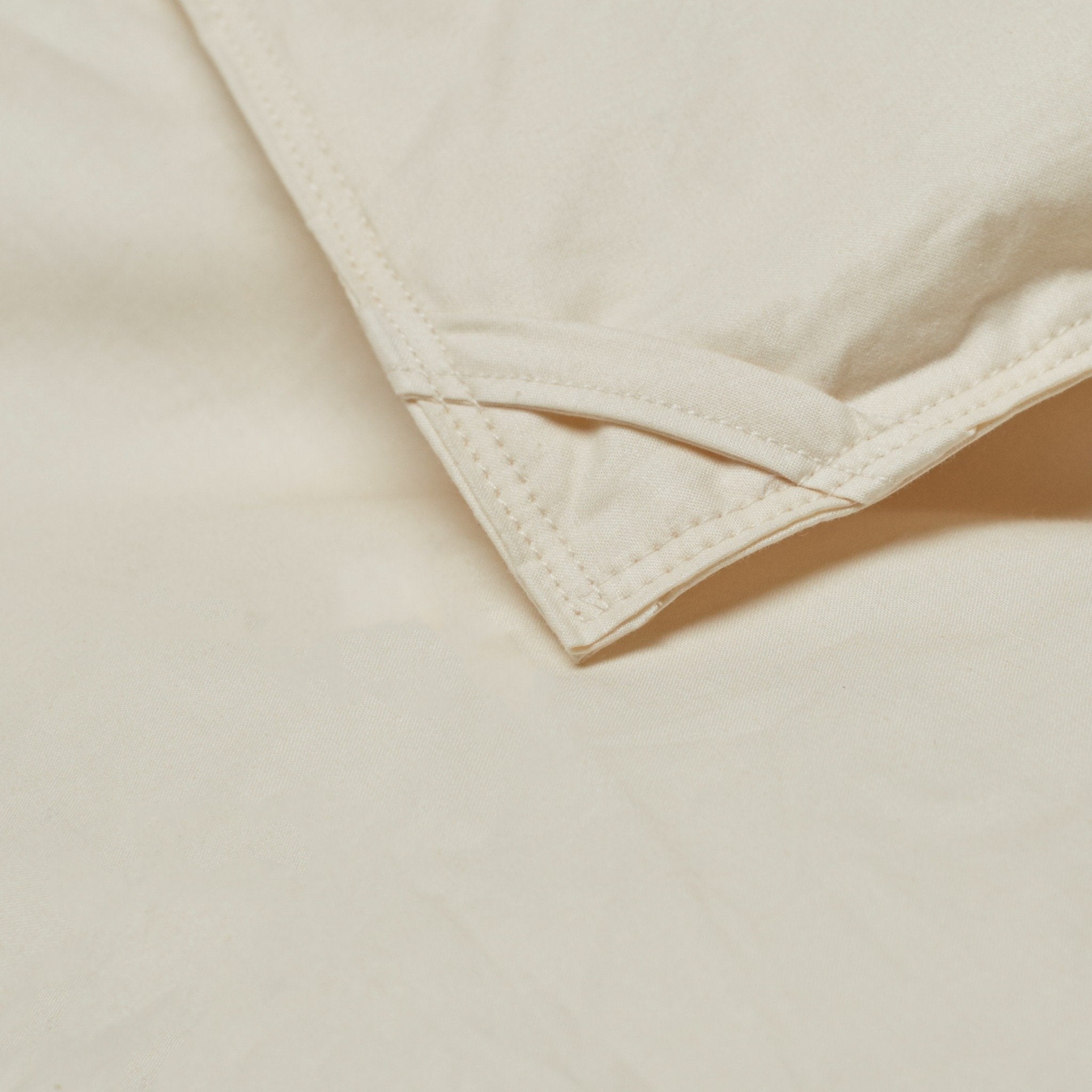 Close-up of a LanaDown Corner Loop with light beige fabric and stitching