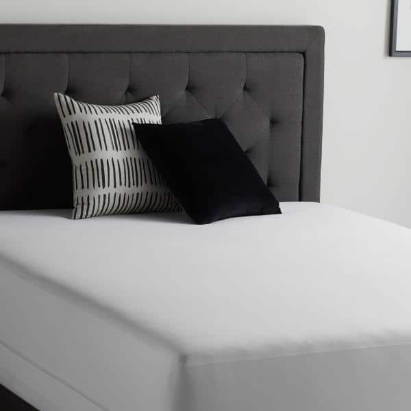 SL0P EP white mattress protector on a bed with a gray headboard