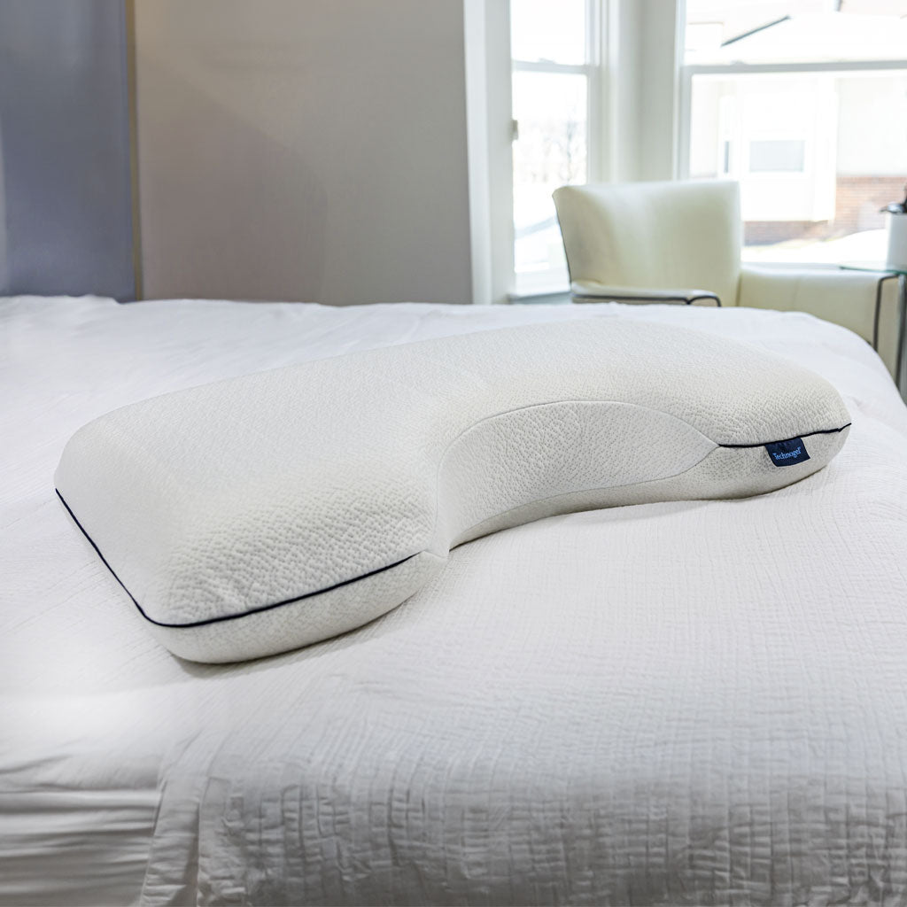 White Technogel SideSleeper Pillow with navy piping on a quilted white bedspread