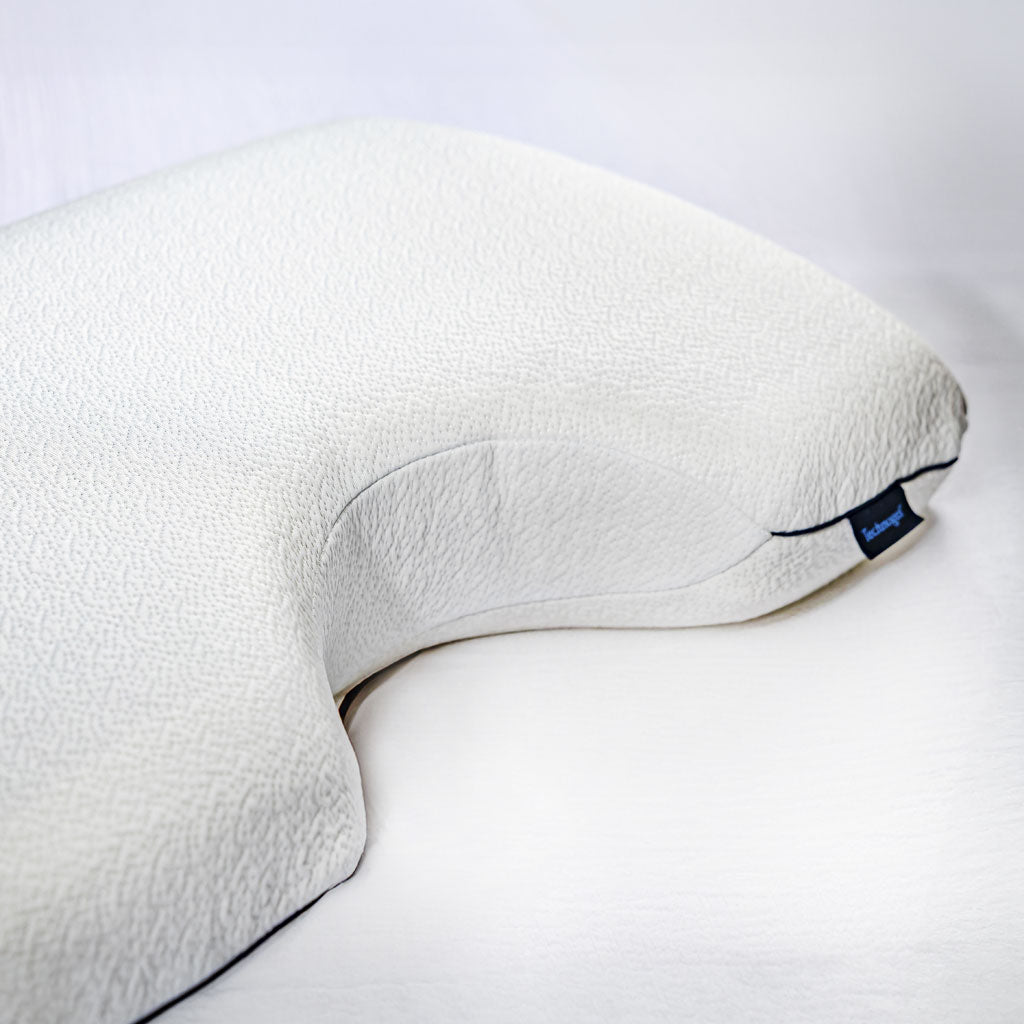 Close up of a white textured Technogel SideSleeper pillow with blue label