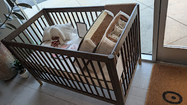Avocado crib mattress installed in a standard crib