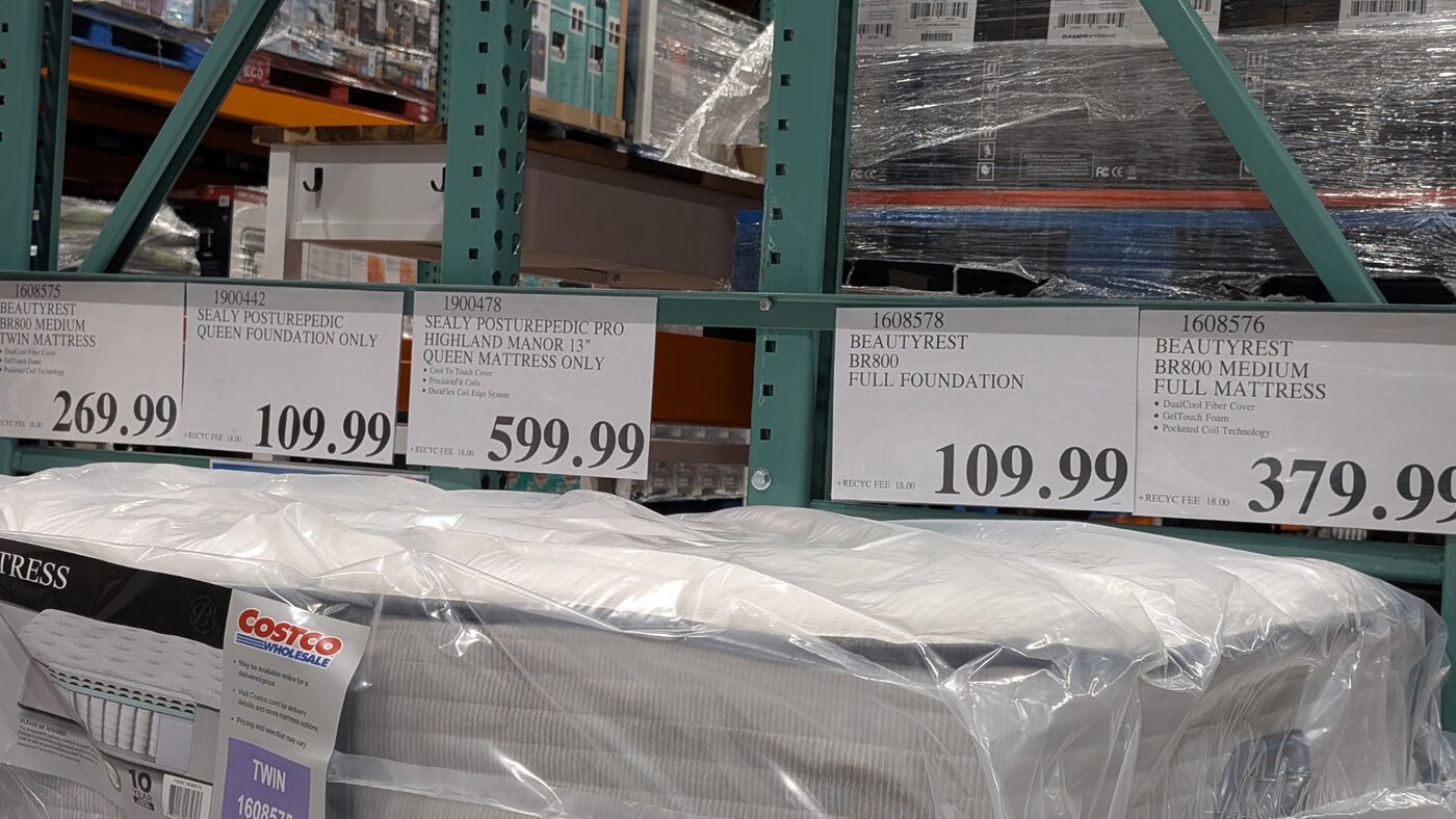 Costco mattress price tags Memorial Day 2026: Beautyrest BR800 twin $269.99, Sealy Posturepedic queen foundation $109.99, Sealy Posturepedic Pro Highland Manor 13-inch queen $599.99, Beautyrest BR800 full foundation $109.99, Beautyrest BR800 medium full $379.99