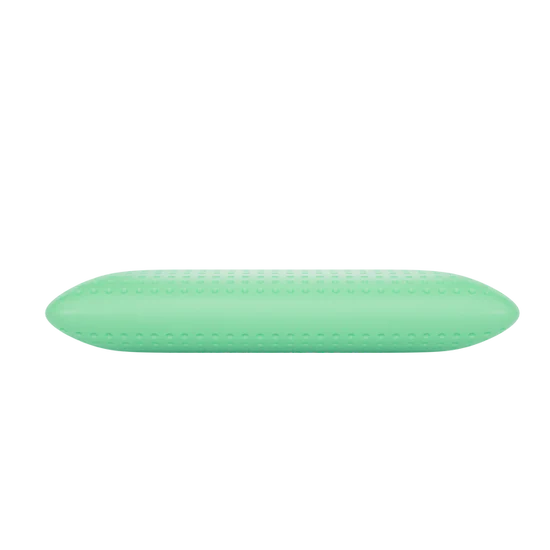Pale green BIO ALOE pillow with a perforated surface on a black background