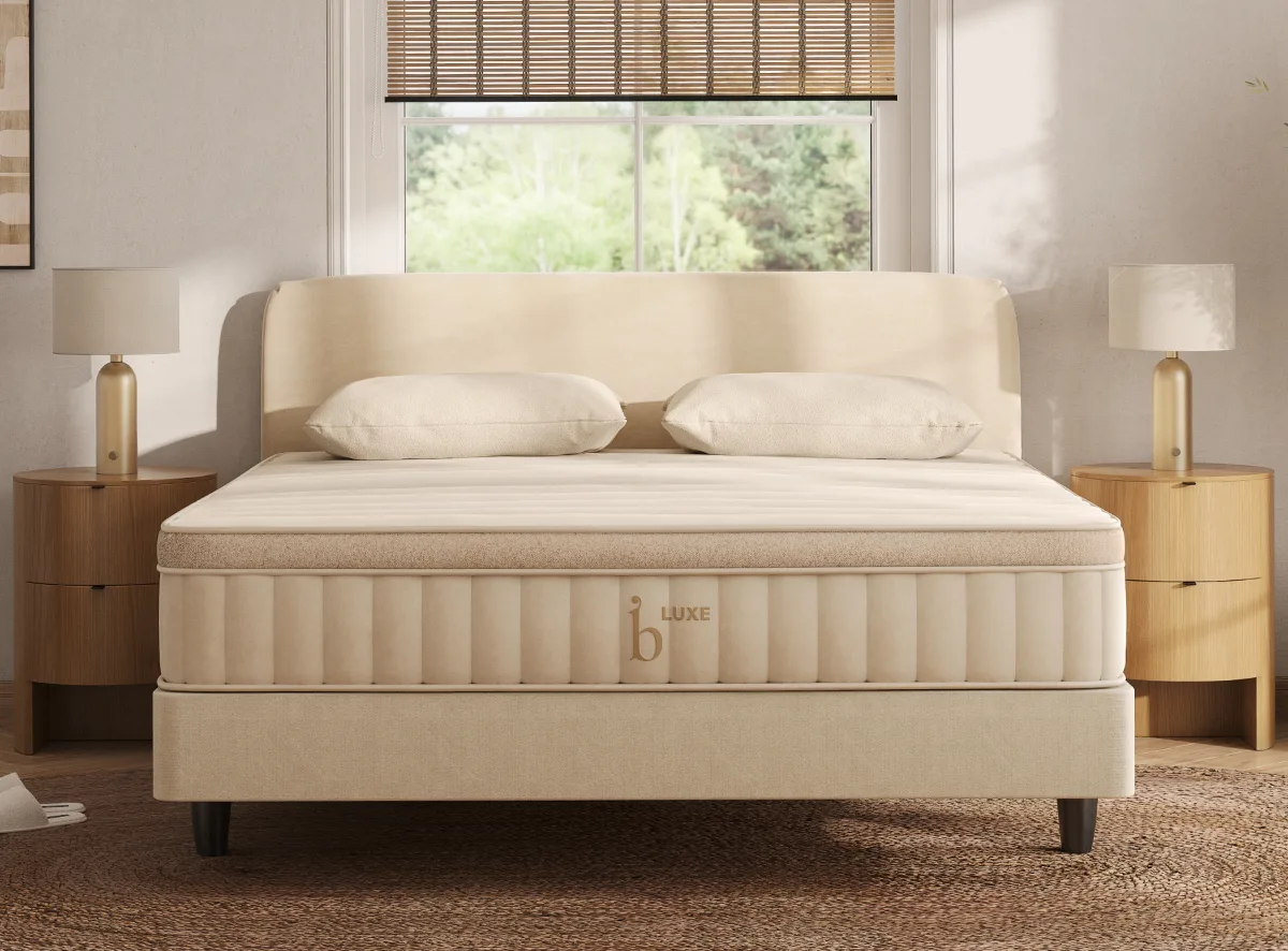 Luxe natural mattress on a beige foundation with an upholstered headboard and pillows