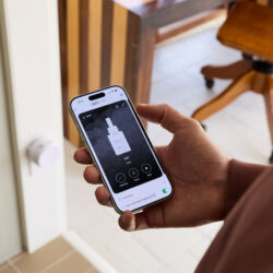 Person holding a phone with "Salt" fragrance diffuser product interface displayed onscreen