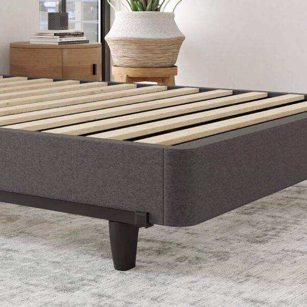 Gray fabric MeetModule bed frame with wooden bed slats on a light gray rug