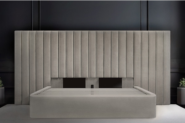 Light gray Milan bed with a tall fluted velvet headboard against dark paneling