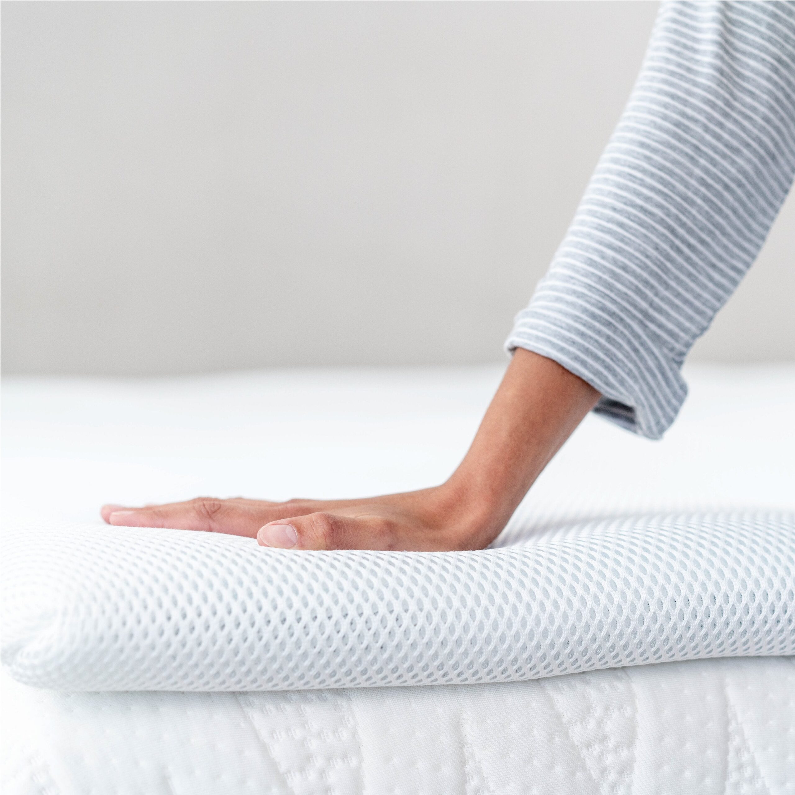 Perfectly Snug Smart Topper on a bed
