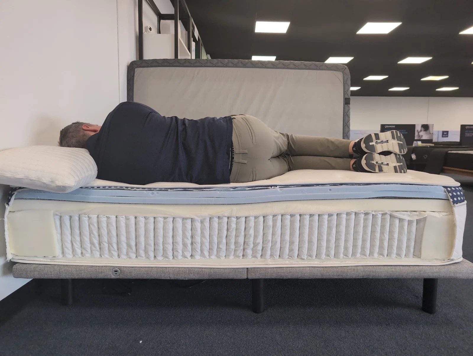 Side sleeper on a WinkBed hybrid mattress showing spinal alignment and the pocketed coil layer
